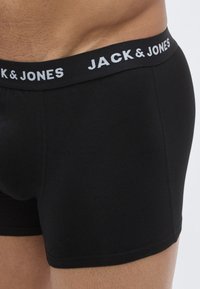 Svarta boxershorts i bomull med bred elastisk midjeresåremed "JACK & JONES"-logga i vitt, åtsittande passform och slät yta.