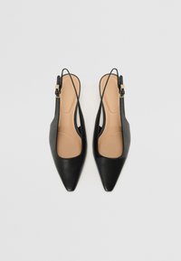 Black leather slingback heels with pointed toes, open sides, and adjustable ankle straps. Features a smooth texture and beige insoles.