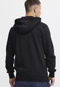 Zwarte hoodie gemaakt van een katoenmix, met een ontspannen pasvorm, elastische manchetten en zoom, en een enkele achternaad.