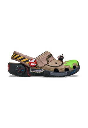 Ghostbusters-themed clog with a black base, green slime detail, and a tan upper. Features a striped strap, decorative hardware, and accents.