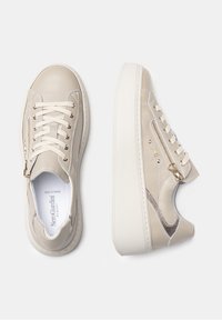 Beżowe skórzane sneakersy o fakturowanym wykończeniu, z sznurowanym przodem, bocznymi zamkami błyskawicznymi oraz grubą białą platformą. Obecne są złote akcenty.