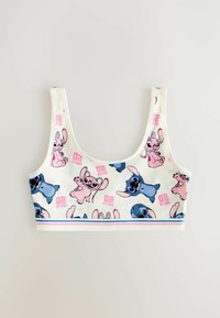 Valkoinen crop-top, jossa on värikkäitä sarjakuvaprinttejä, esittäen vaaleanpunaisia ja sinisiä sarjakuvahahmoja. Pehmeä kangas, leveät olkaimet ja joustava vyö.