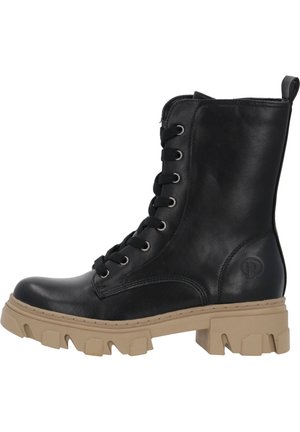 Black leather ankle boot with chunky beige sole, lace-up front, logo detail on side, and textured finish. Designed for durability and traction.