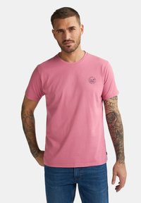 Rosa Kurzarm-T-Shirt aus weicher Baumwolle mit Rundhals, ausgestattet mit einer kleinen schwarzen Grafik auf der Brust und einem geraden Saum.