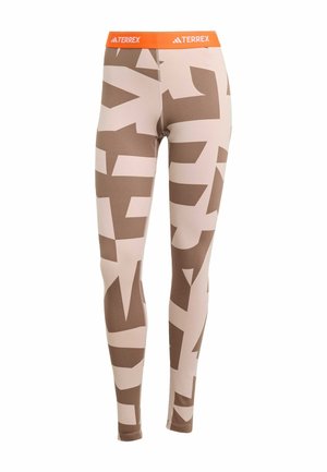 Terrex-Leggings mit beige Grundfarbe, versehen mit großen braunen abstrakten Mustern. Elastischer oranger Bund mit dem "TERREX"-Logo auf der Vorderseite.