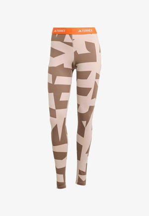 Terrex leggings with a beige base, featuring large brown abstract patterns. Elastic orange waistband with "TERREX" logo at the front.