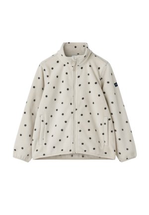 Kermansävyinen fleecetakki mustakuvioisilla pilkuilla, vetoketju edessä, korkea kaulus ja sivutaskut. Pehmeä tekstuuri ja rento muotoilu.