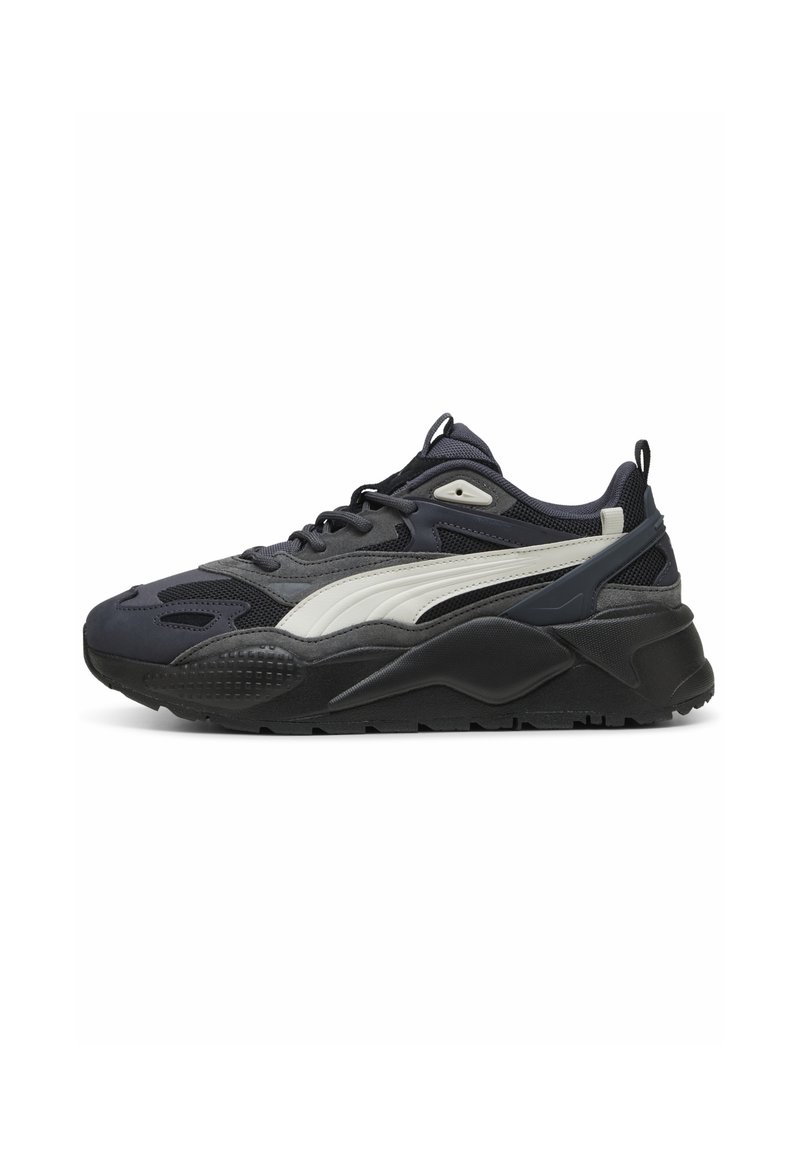 Puma sneakers featuring a dark gray upper, white side stripe, textured black sole, mesh panels, and rounded design for comfort.