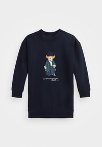 Laivastonsininen collegepaita, joka on valmistettu puuvillasekoitekankaasta. Edessä värikäs brodeerattu pukuun pukeutunut karhukuva. Pyöreä pääntie ja resorit hihansuuissa.