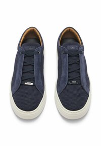 Navy sneakers with mesh and suede upper, flat dark laces, and white rubber sole. Features a branded accent on the tongue.