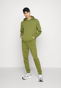 Puma BETTER ESSENTIALS - Træningsbukser - olive green