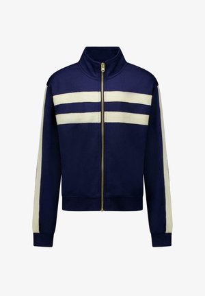 Donkerblauw jack met ritssluiting, twee horizontale witte strepen op de borst en verticale witte strepen langs de mouwen, geribbelde boorden en zoom.