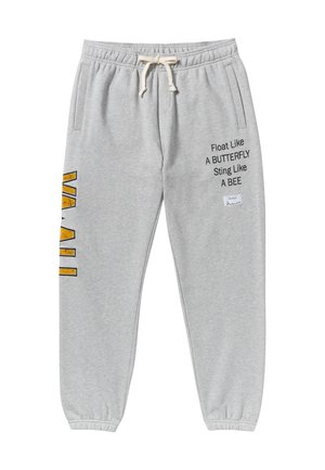 Pantalons de jogging gris en mélange de coton, dotés de poches latérales, d'une taille élastique avec cordon de serrage, et d'imprimés en texte et graphiques en noir et jaune.