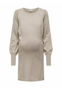 Gravidklänning i ljus beige, med en slät kropp och texturerade puffärmar med hålmönster. Rund halsringning och långa ärmar.