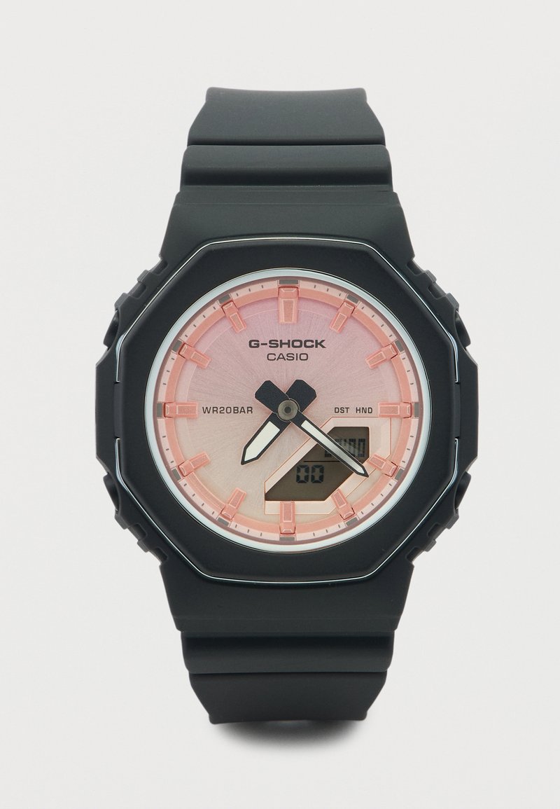 Μαύρο ρολόι χειρός Casio G-Shock με ροζ καντράν, αναλογικούς δείκτες, ψηφιακή οθόνη και μαύρο λουράκι από καουτσούκ.