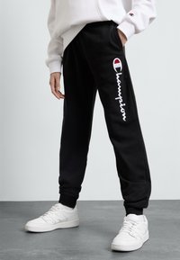 Champion - ICONS CUFF PANTS CONTRAST LOGO UNISEX - Tracksuit bottoms - new black Thumbnail Image 1