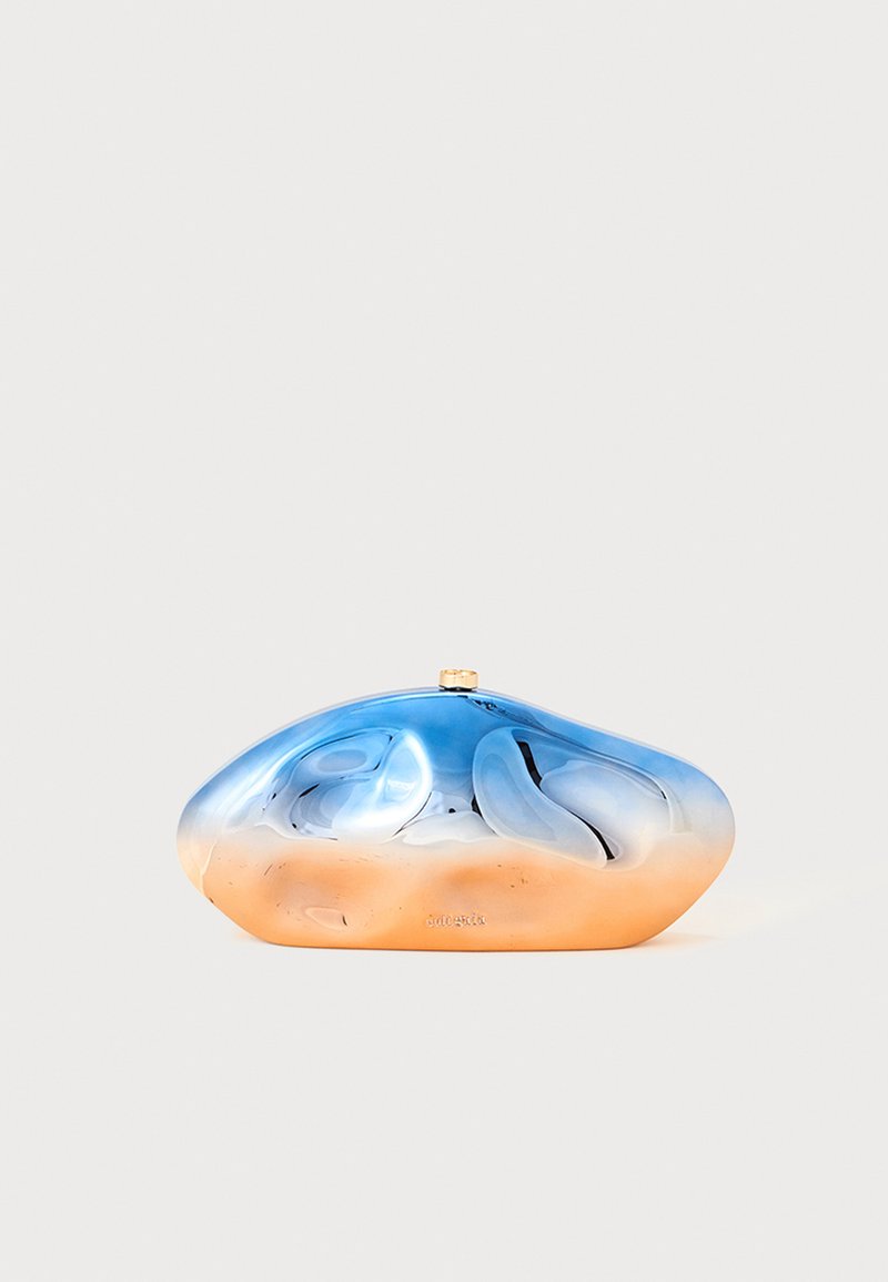 Bolso de mano con degradado azul y naranja, acabado suave y brillante, y forma orgánica y redondeada; cuenta con un cierre metálico.