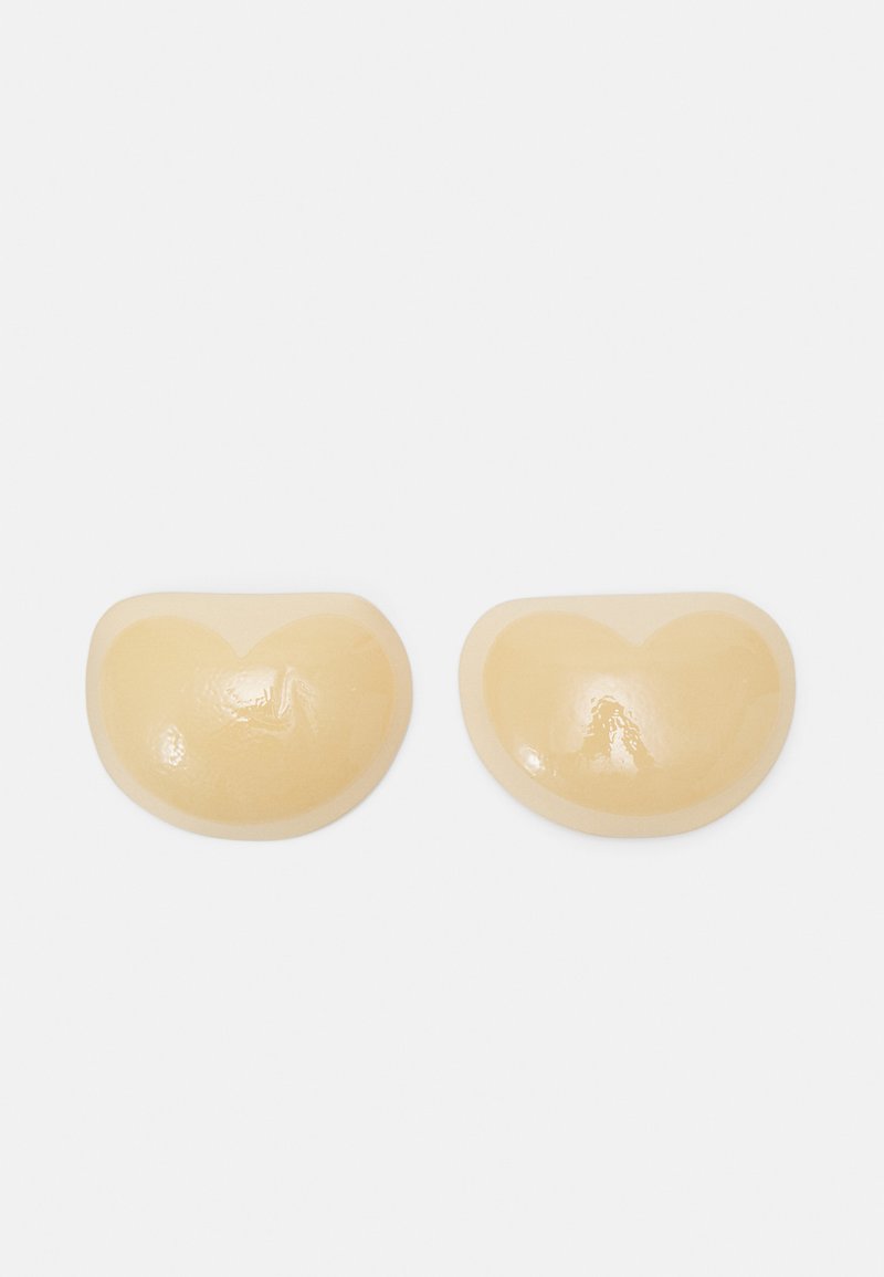 Nude silicone bra cups with a smooth, glossy surface and a rounded, heart-shaped design, lightweight and flexible for discreet support.
