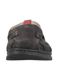 Dark gray leather sandal featuring cut-out designs, a red accent at the heel, and a textured black rubber sole.
