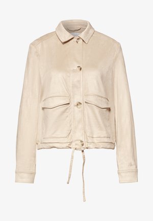 Beige nappitettava takki, jossa kaulus, kaksi etutaskua läpällä, pitkät hihat ja nyörisäätö helmassa.