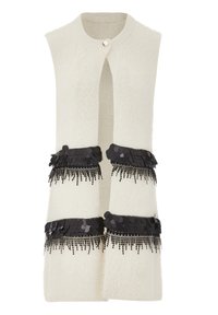 Cream-colored sleeveless vest with a fuzzy texture, featuring two black sequin and fringe embellishments at the waist and a front button closure.