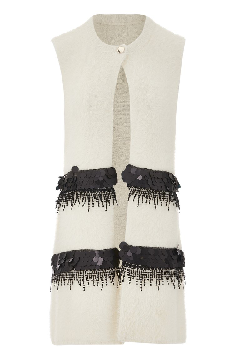Cream-colored sleeveless vest with a fuzzy texture, featuring two black sequin and fringe embellishments at the waist and a front button closure.