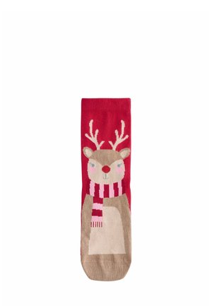 Red socks featuring a reindeer design with antlers, a pink nose, and a striped scarf. Made of soft material with a smooth texture.