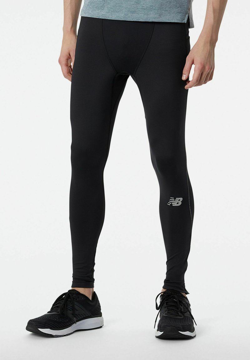 Leggings atletici neri realizzati in materiale liscio e elastico, con una vestibilità aderente, accento del logo in argento e design lungo fino alla caviglia.
