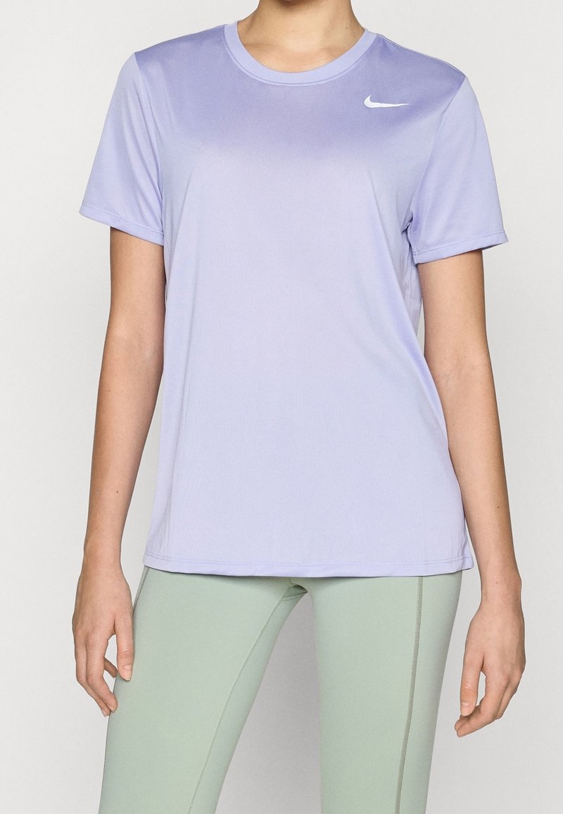 Camiseta Nike de color púrpura claro, de manga corta y fabricada con tela suave. Presenta un cuello redondo y un logotipo sutil en el lado izquierdo del pecho.