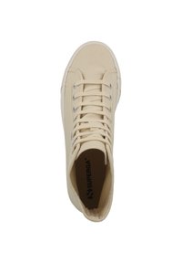 Beige canvas high-top sneaker featuring a round toe, textured upper, six eyelets, and a white rubber sole. Interior logo visible.