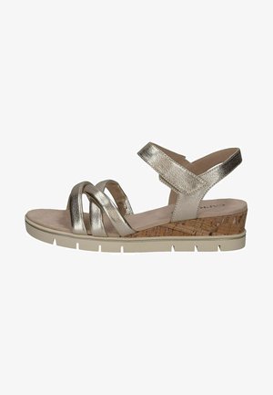 Metallic gold sandals with crossband straps, cork wedge heel, beige sole, and smooth texture. Closed back with adjustable ankle strap.