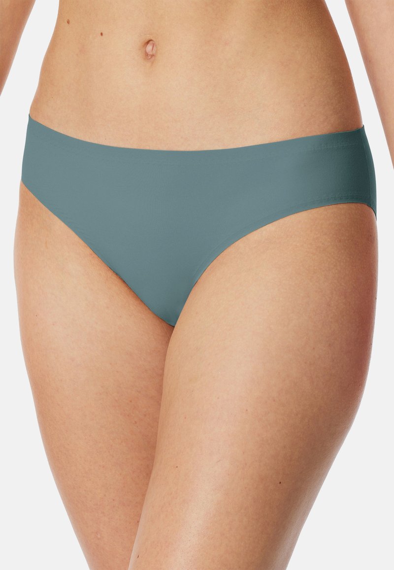 Teal bikini bottom with a smooth finish, low-rise design, minimalistic style, and seamless edges. Fabric appears stretchy and comfortable.