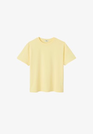 T-shirt uni jaune pâle à manches courtes et col rond, présenté sur un fond blanc.