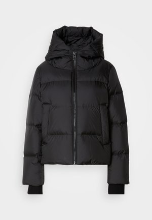 Giacca puffer nera con colletto alto, chiusura con zip, tasche laterali e polsini a costine. Il design trapuntato aggiunge texture e isolamento.
