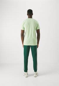 adidas Performance ESSENTIALS FEELREADY - Sportska majica - semi green spark/green spark