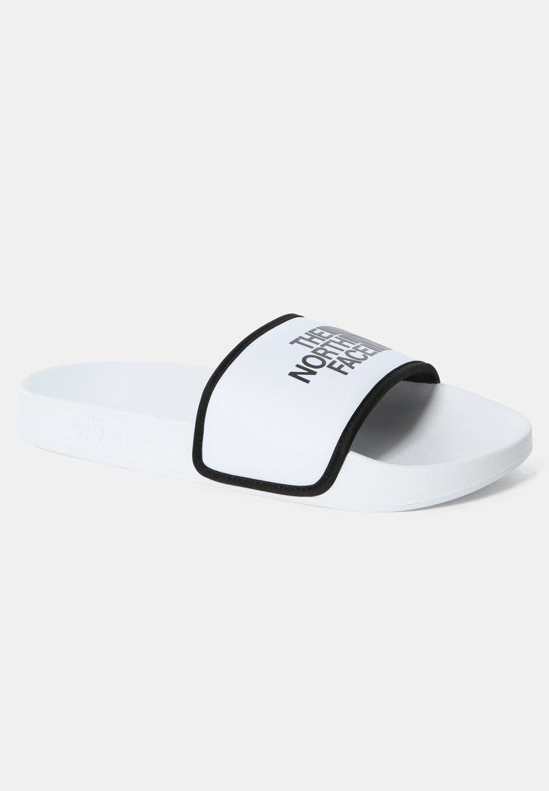 Biele sklzde s čiernym okrajom a širokým remienkom, na ktorom je na hornej strane zobrazené "THE NORTH FACE" tučným šedým písmom. Hladký povrch.