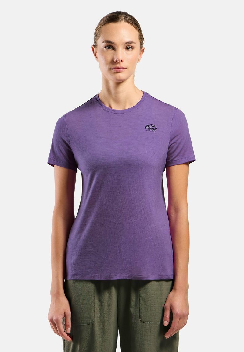 Purple short-sleeve t-shirt made of soft fabric, featuring a round neckline and a small black graphic detail on the left chest.