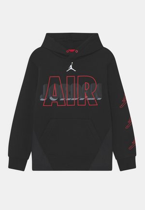 Sweat à capuche noir avec texte "AIR" en contour rouge, ombre "JORDAN" grise, logo Jumpman blanc au-dessus, et logos Jumpman rouges le long de la manche droite.