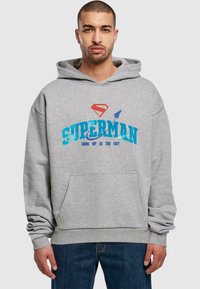 Gray hooded sweatshirt with front pocket, featuring a blue "SUPER" text and Superman emblem in red, with "LOOK UP IN THE SKY" below.