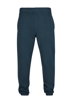 Marineblå joggebukser laget av mykt materiale med elastisk midje og tettsittende mansjetter ved anklene, med en glatt tekstur og uten synlige mønstre.