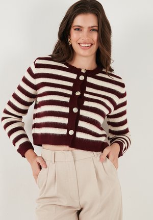 Burgundy and cream striped cardigan featuring a cropped design, button front, and ribbed cuffs, made from a soft, textured fabric.