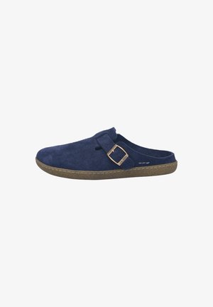Navy blue suede slip-on clog with adjustable strap and bronze buckle on a brown textured sole.