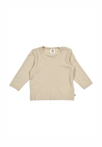 Hladký béžový dlouhý rukáv s kulatým výstřihem, malým ramenním cvokem a vyšitým logem na spodním levém švu.