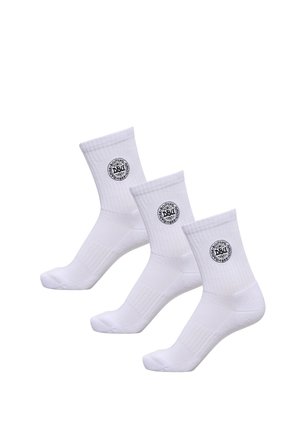 Cotton crew socks in white with ribbed texture; features a circular black logo on each sock. Three pairs displayed in a row.