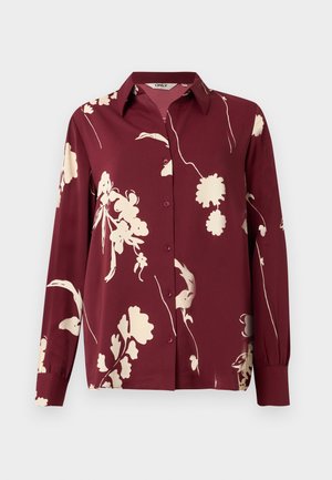 Chemise à manches longues bordeaux avec un motif floral crème, fermeture à boutons, col pointu et détails de poignets élastiques. Tissu lisse et léger.