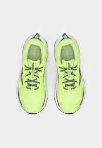 Lime green running shoes with breathable mesh upper, gray accents, black laces, and a cushioned sole. Tread detail visible on the bottom.
