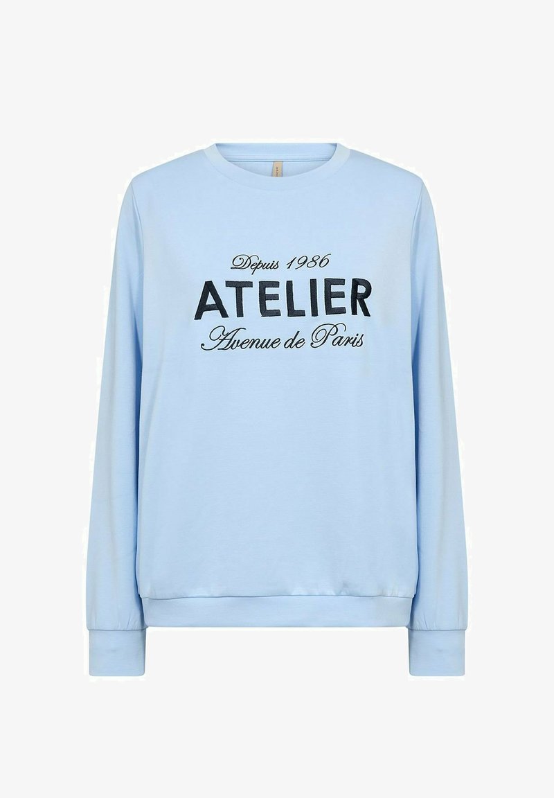 Light blue long-sleeve sweatshirt with round neckline, featuring black text printed: "ATELIER Avenue de Paris" with vintage year 1986.