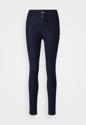 Mørkeblå skinny jeans lavet af denim, med lynlås og knaplukning, samt kontraststing langs sømmene.