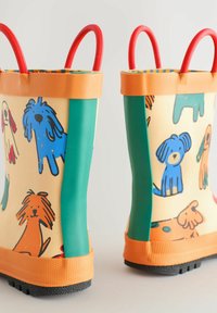 Bunte Gummistiefel mit einem beigen Körper, der mit mehrfarbigen Hundebildern verziert ist, grünen Seiten und roten Griffen. Strukturierte schwarze Sohle für besseren Halt.