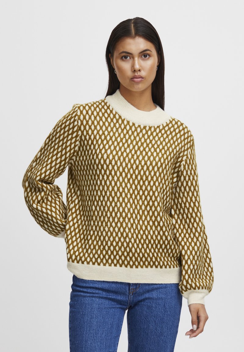 Maglione lavorato a maglia con un motivo a rombi nei colori senape e crema, con colletto girocollo a costine e maniche a sbuffo, realizzato in un tessuto morbido.